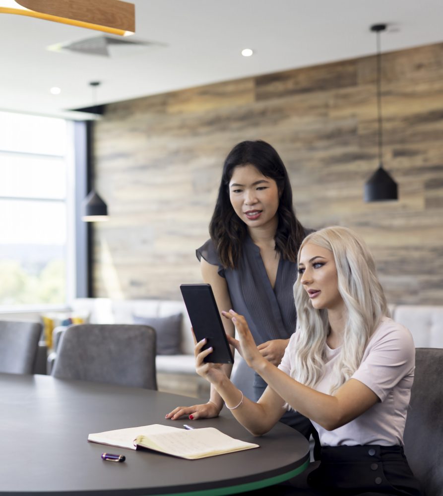 Strata managers reviewing a plan of subdivision in boardroom
