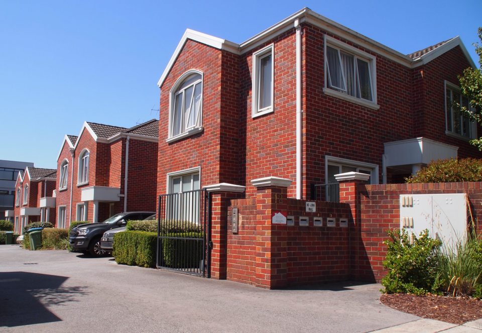 Townhouse body corporate with common driveway and gardens