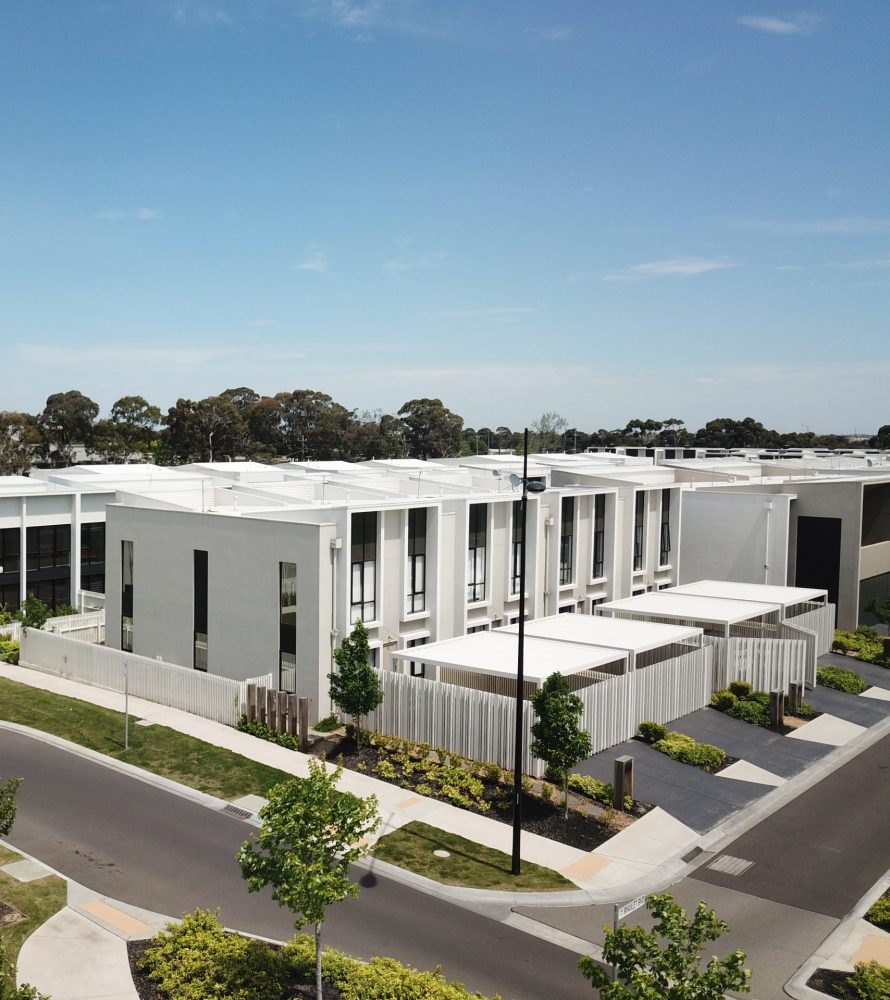 Drone image of body corporate townhouse with common gardens and driveway