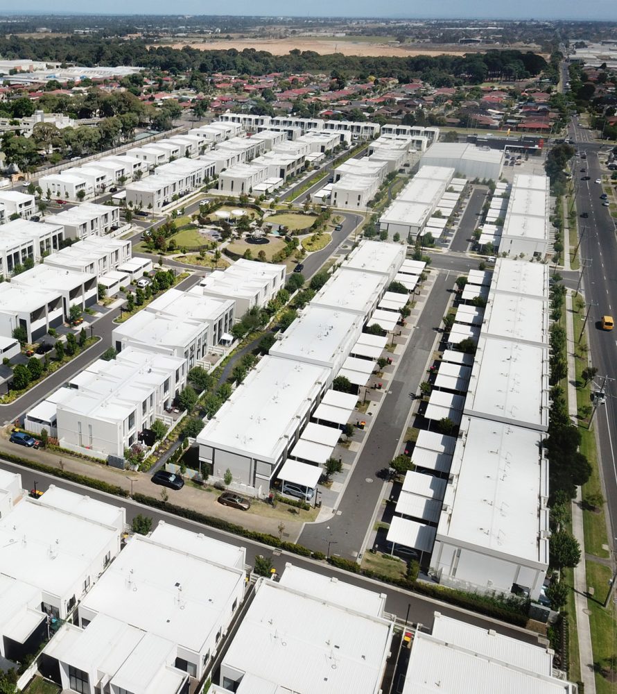 Drone image of body corporate townhouse with common gardens and driveway