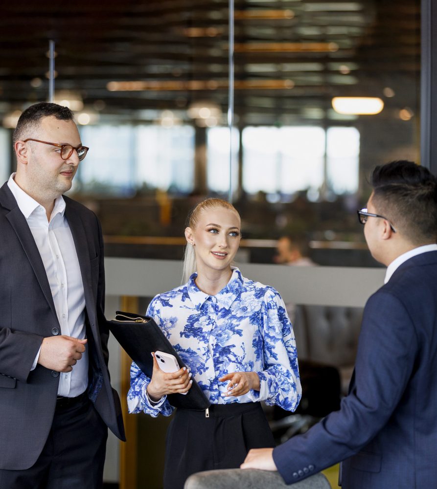 Body corporate managers in a board room discussing a plan of subdivision Body corporate managers in a board room discussing a plan of subdivision