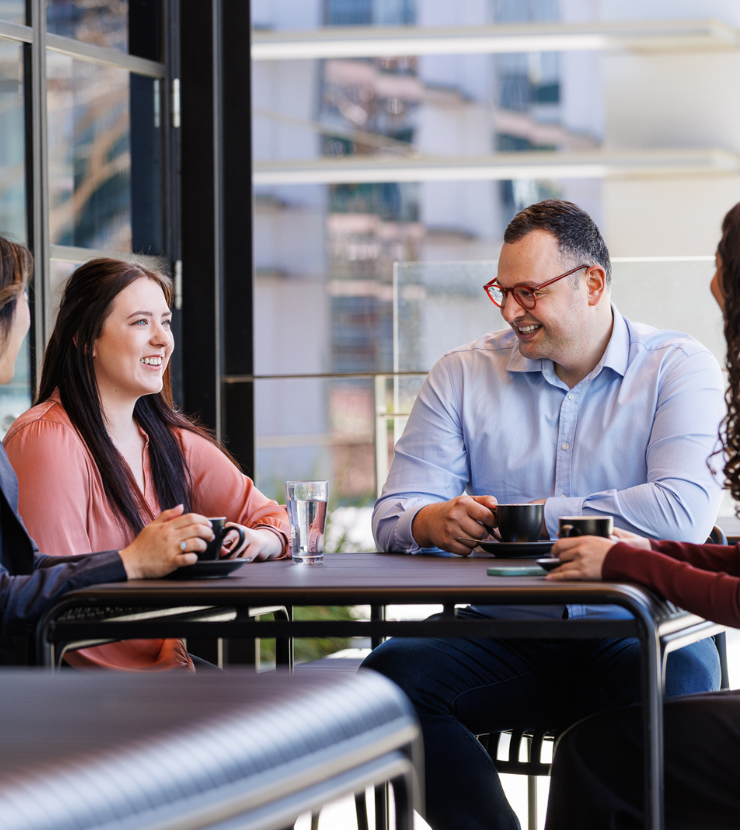 Strata managers enjoying a coffee break with colleagues